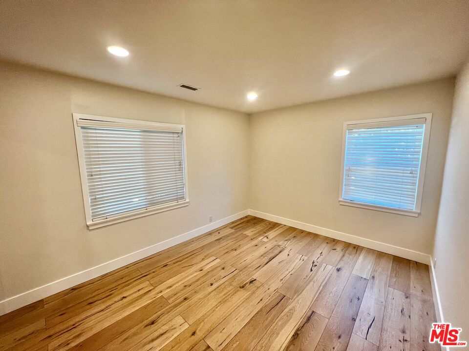 5757 Vesper Avenue Van Nuys, CA 91411 - Photo 14 of 26 a view of an empty room with wooden floor and a window