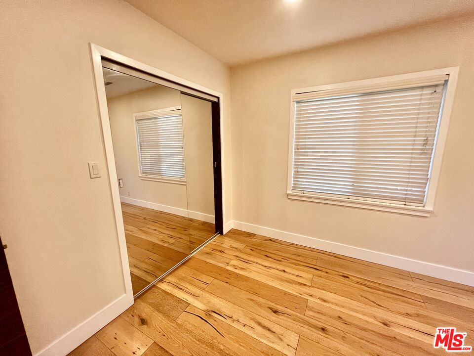 5757 Vesper Avenue Van Nuys, CA 91411 - Photo 15 of 26 a view of an empty room with wooden floor and a window