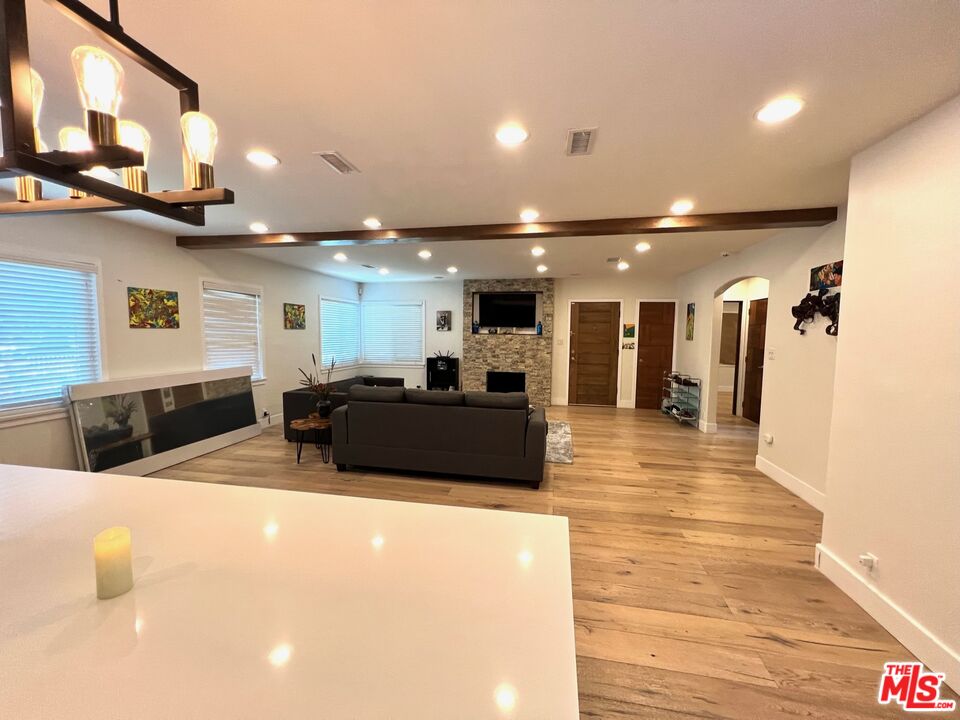 5757 Vesper Avenue Van Nuys, CA 91411 - Photo 5 of 26 a large room with lots of furniture and a wooden floor