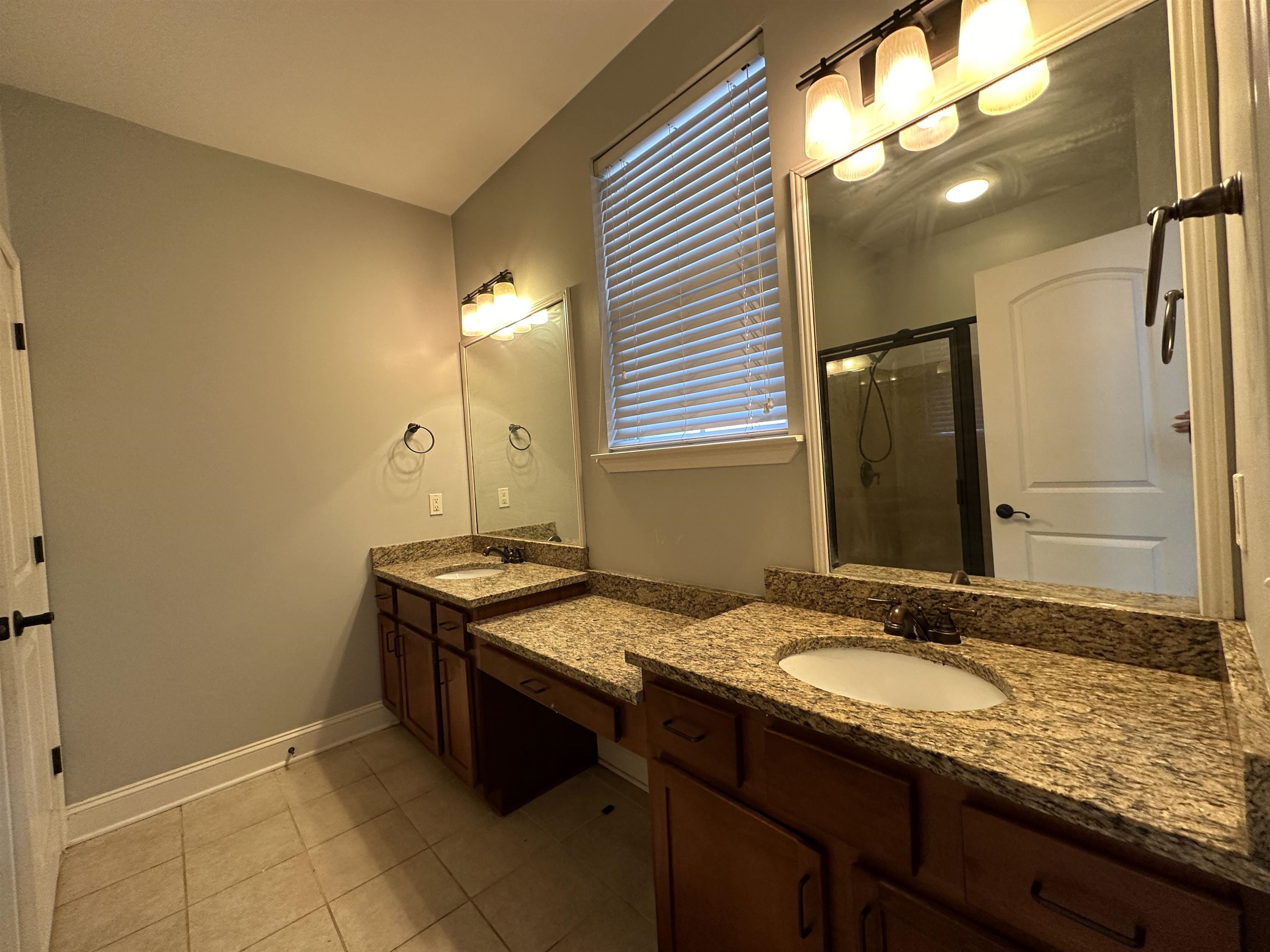 75 Shoemaker Court, Unit 304 Memphis, TN 38103 - Photo 11 of 25 Bathroom featuring tile floors, dual sinks, a shower with door, and large vanity