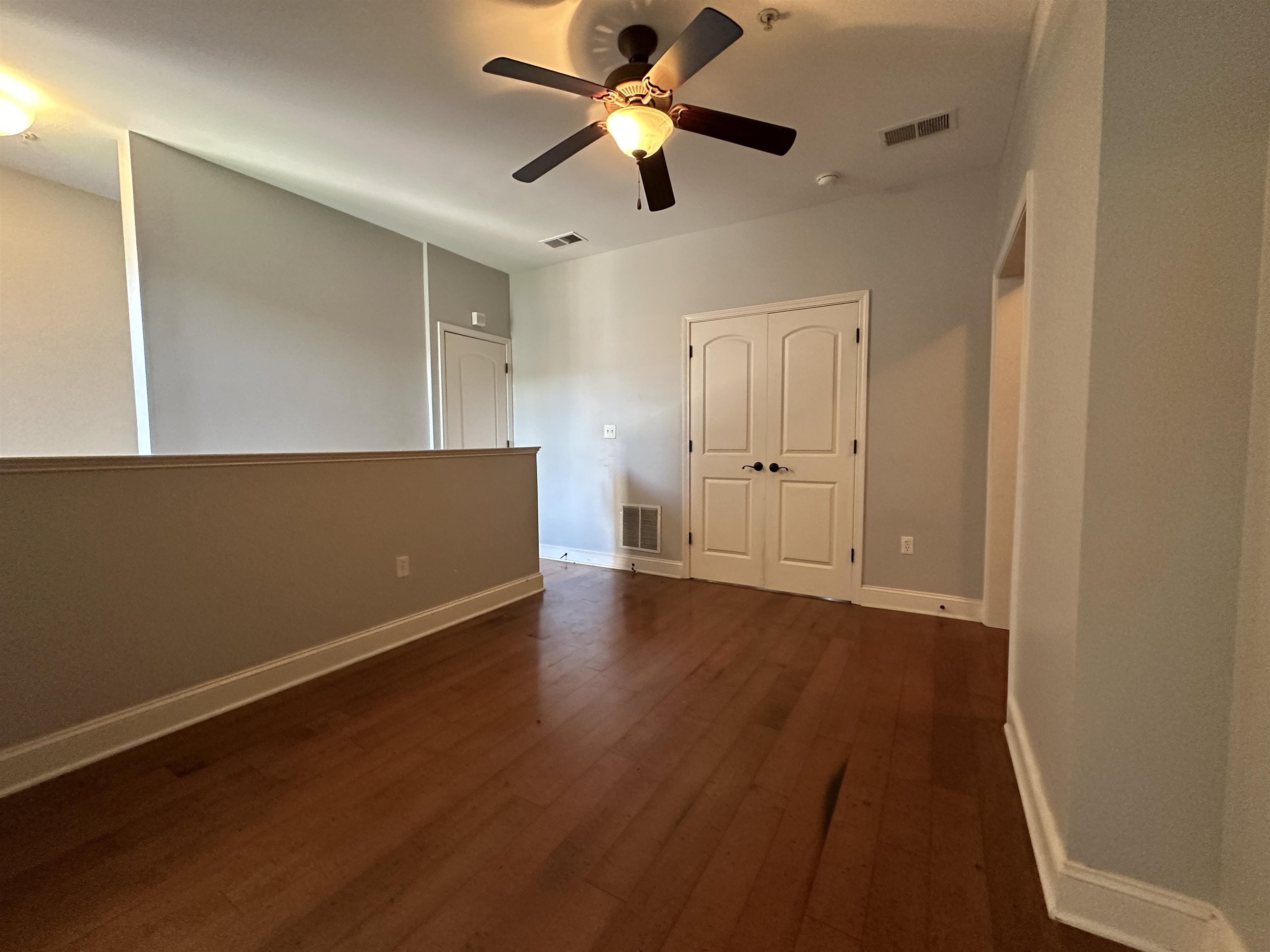 75 Shoemaker Court, Unit 304 Memphis, TN 38103 - Photo 16 of 25 Unfurnished room featuring dark hardwood / wood-style flooring and ceiling fan