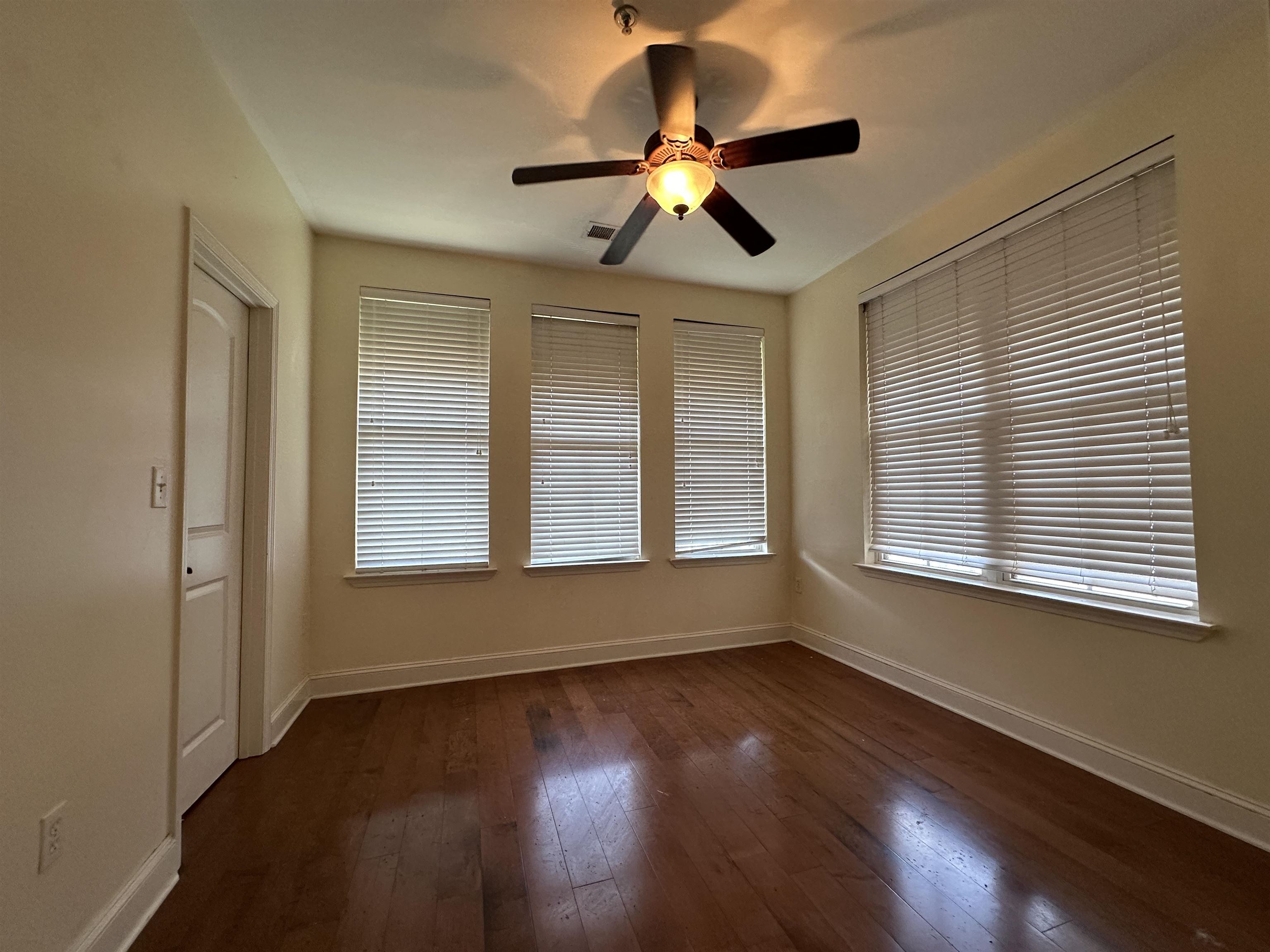 75 Shoemaker Court, Unit 304 Memphis, TN 38103 - Photo 17 of 25 Unfurnished room featuring ceiling fan and dark hardwood / wood-style flooring