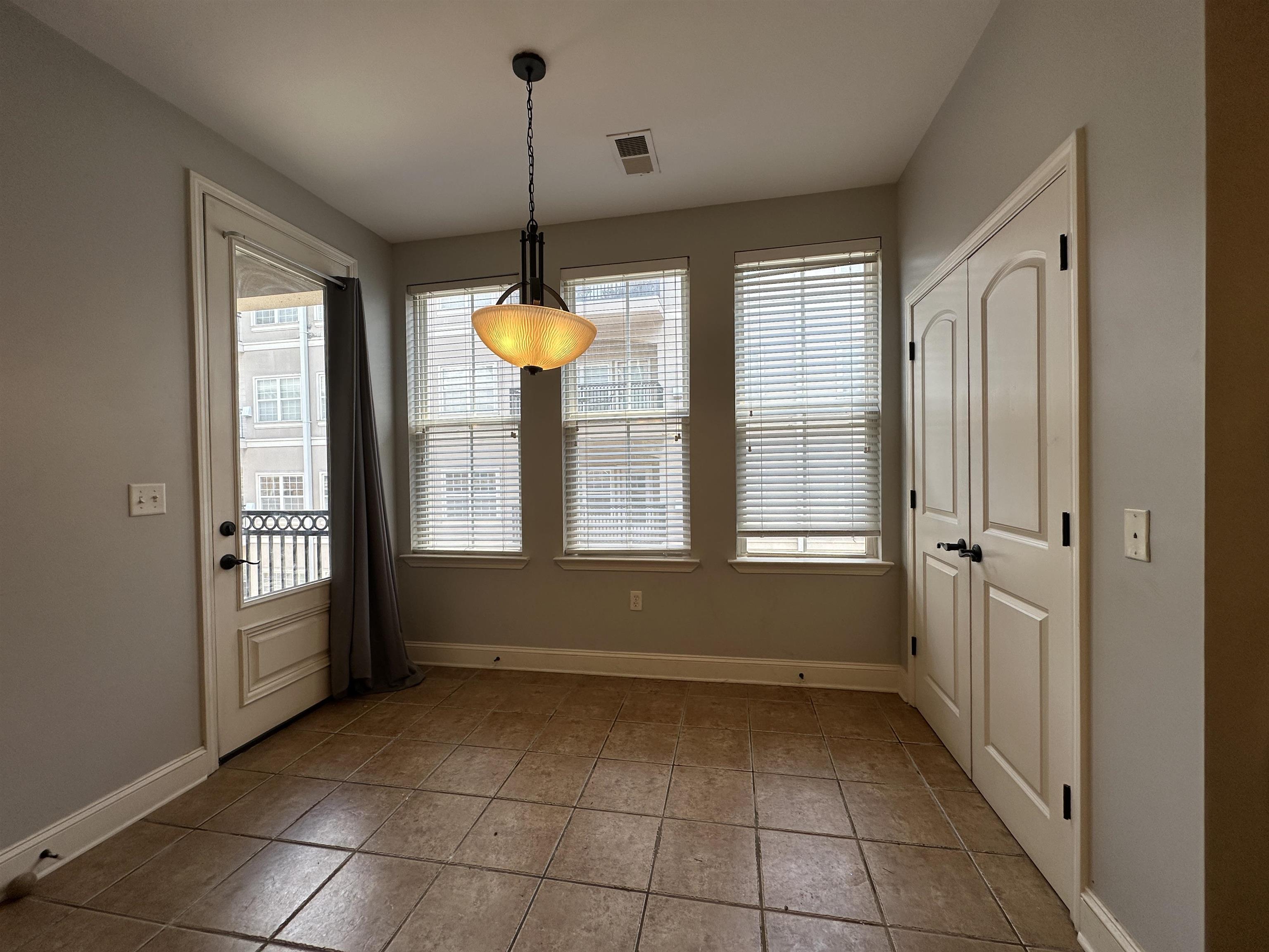 75 Shoemaker Court, Unit 304 Memphis, TN 38103 - Photo 7 of 25 Unfurnished dining area featuring plenty of natural light and tile floors