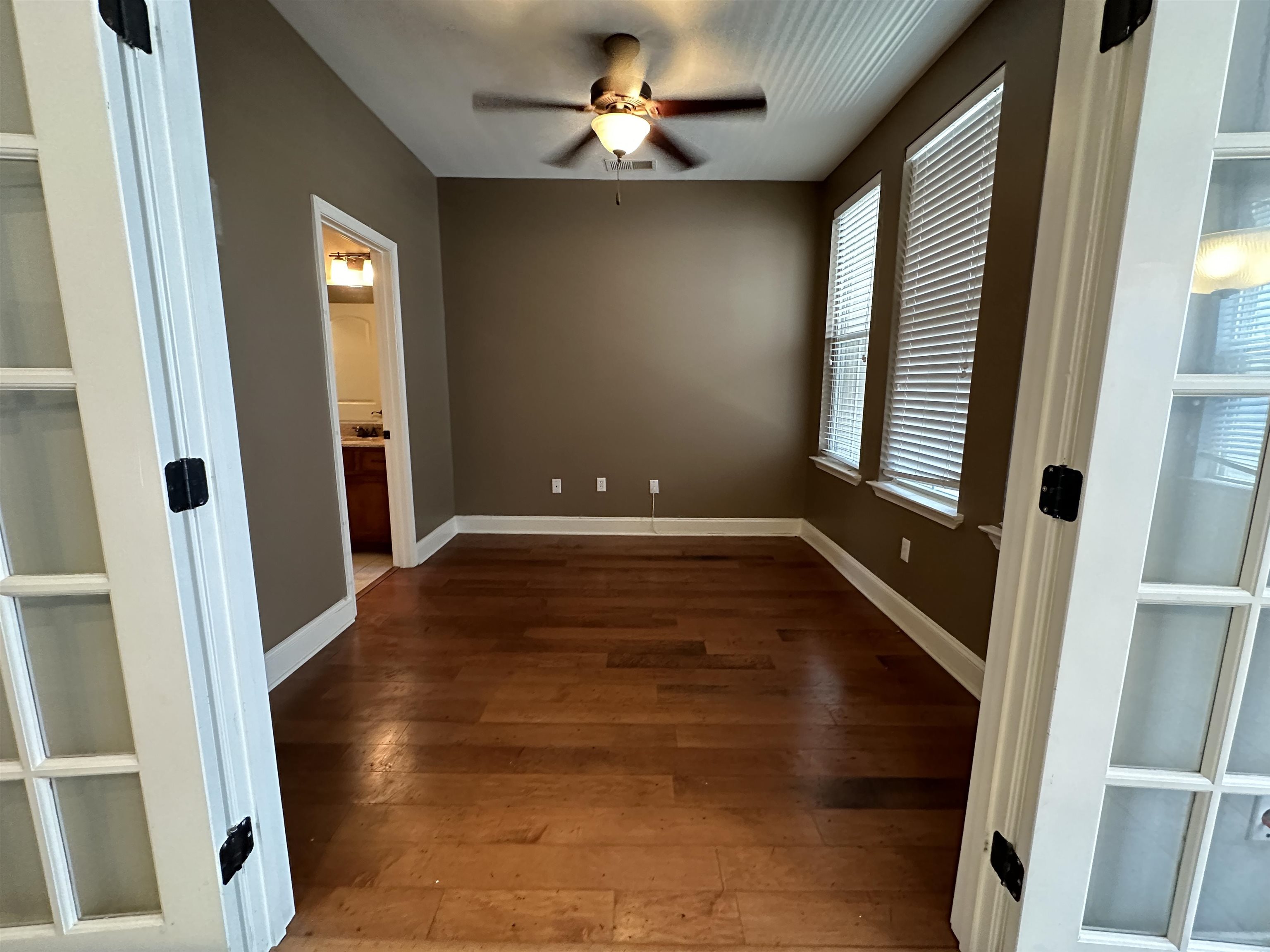75 Shoemaker Court, Unit 304 Memphis, TN 38103 - Photo 8 of 25 Empty room featuring hardwood / wood-style floors and ceiling fan