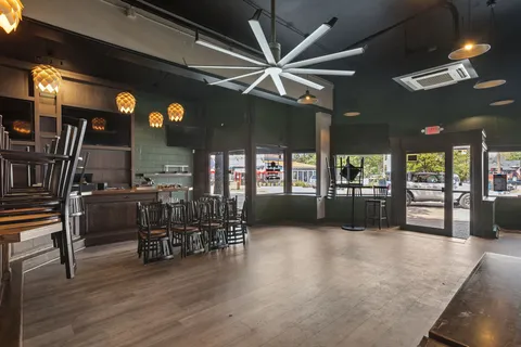 a room with lots of wooden furniture and a chandelier