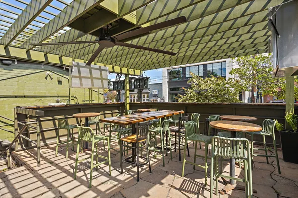 a view of a swimming pool with a bench and lawn chairs
