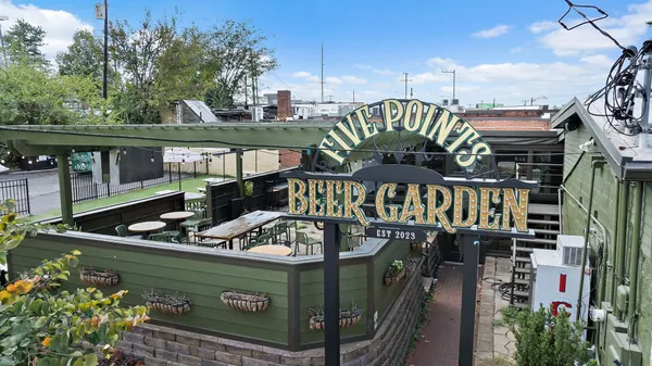 a view of a parked cars park in front of building