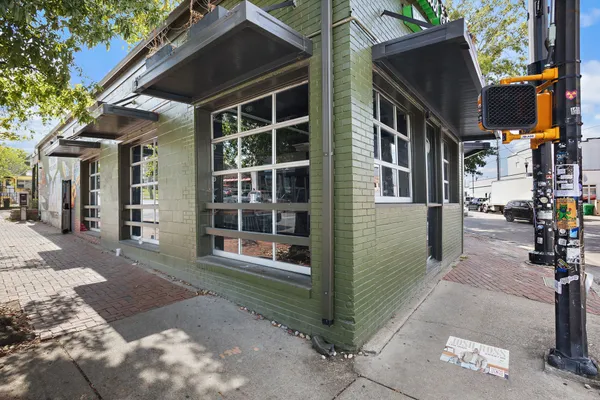 a view of a brick house with many windows