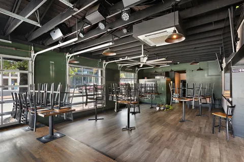 a room with wooden floor and white walls