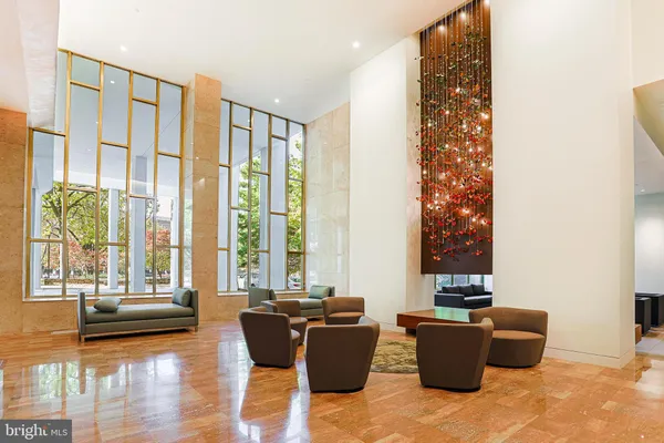 a living room with furniture and large windows