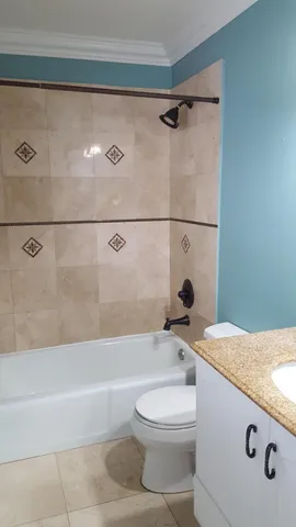 a kitchen with a sink a counter top space and cabinets