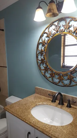 a kitchen with stainless steel appliances granite countertop a sink and a refrigerator