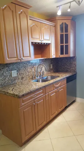 a kitchen with granite countertop a stove and a microwave