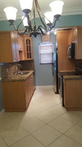 a view of a backyard with a garden and deck