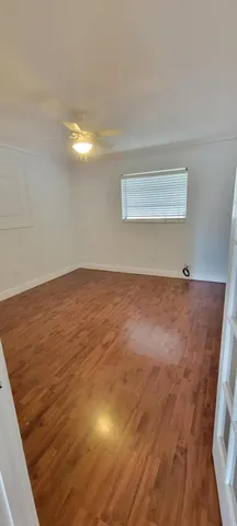 a bathroom with a granite countertop bathtub shower sink vanity and toilet