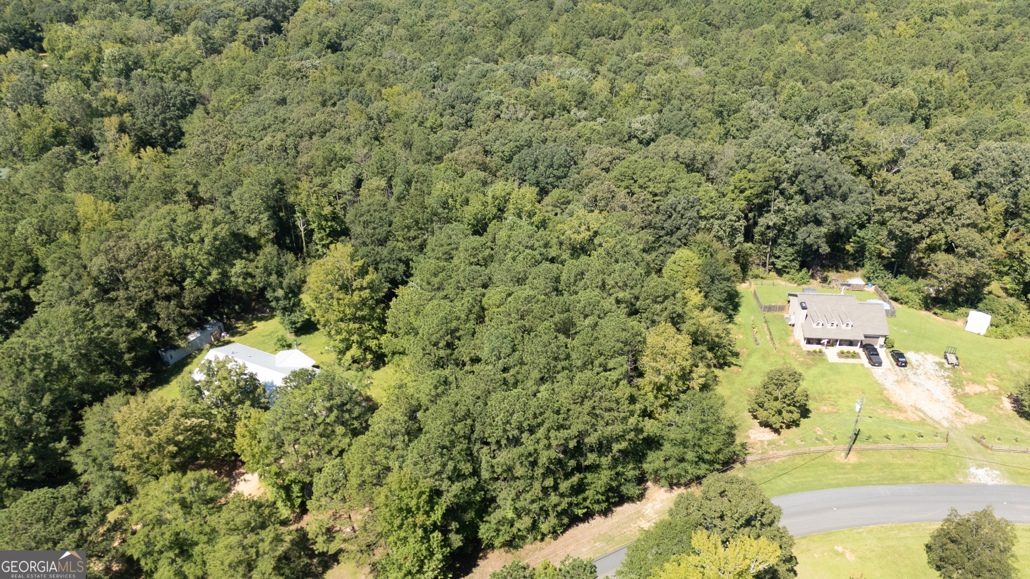 0 Malcom Road Covington, GA 30014 - Photo 3 of 5 a view of a yard with plants and large trees