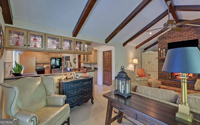 a living room with furniture and a floor to ceiling window