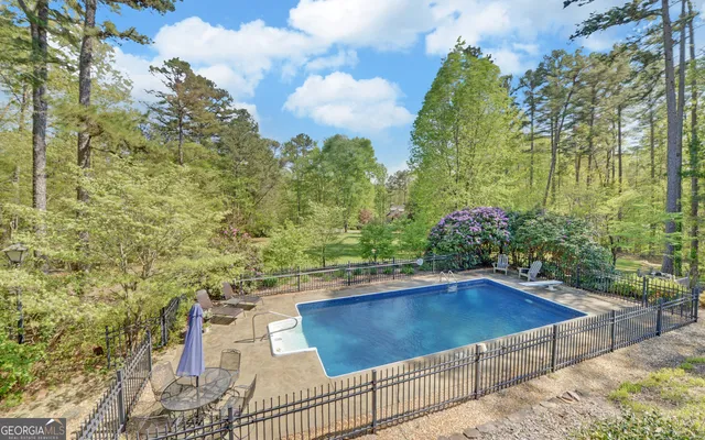 a view of a big yard with large trees