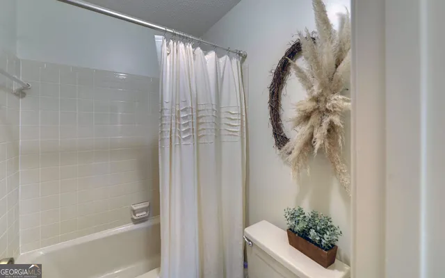 an empty room with fireplace and windows