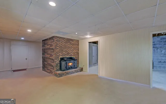 a view of backyard with a barn and a large tree