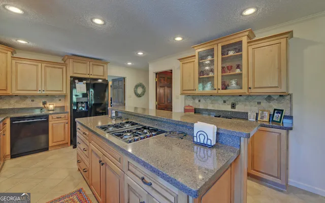 a kitchen with a sink stove and cabinets