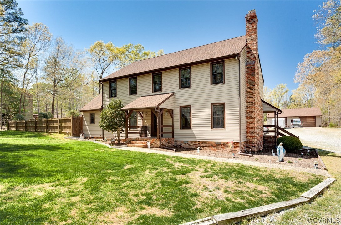 a view of a house with a yard patio and fire pit