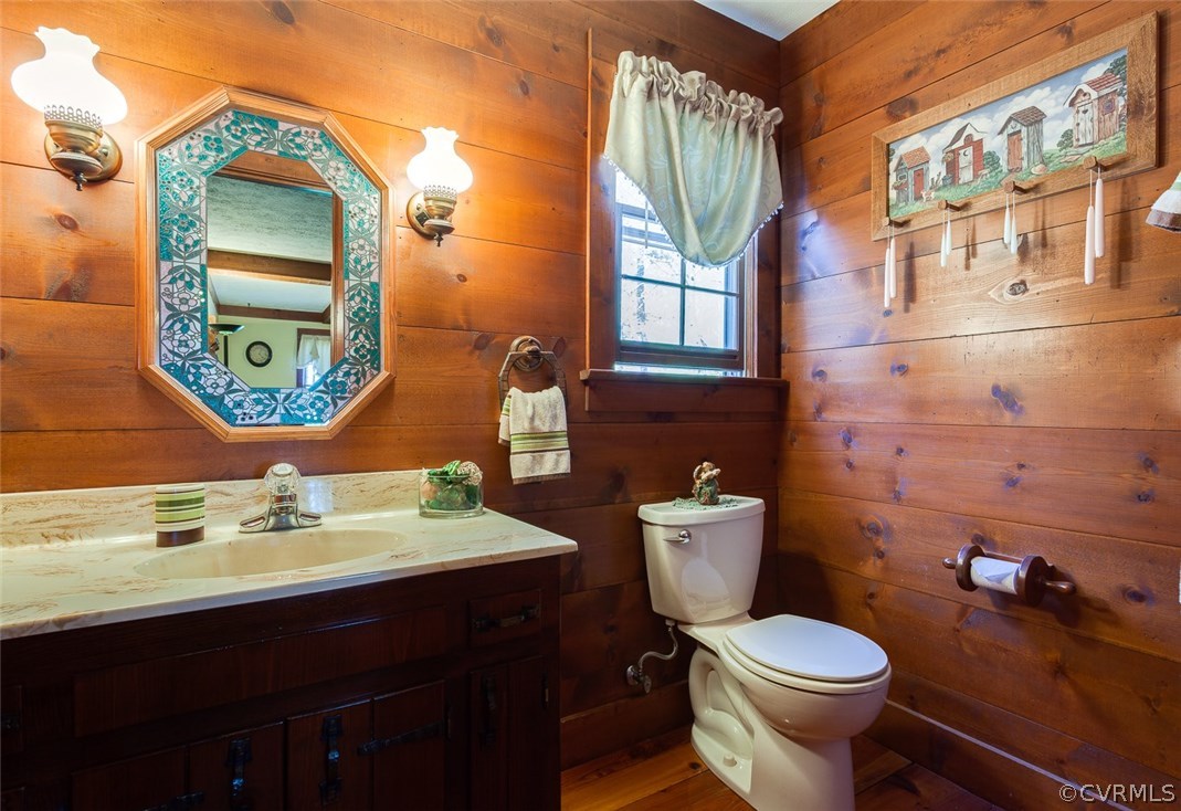 15210 Harrowgate Road Chester, VA 23831 - Photo 12 of 26 a bathroom with a toilet a sink and mirror