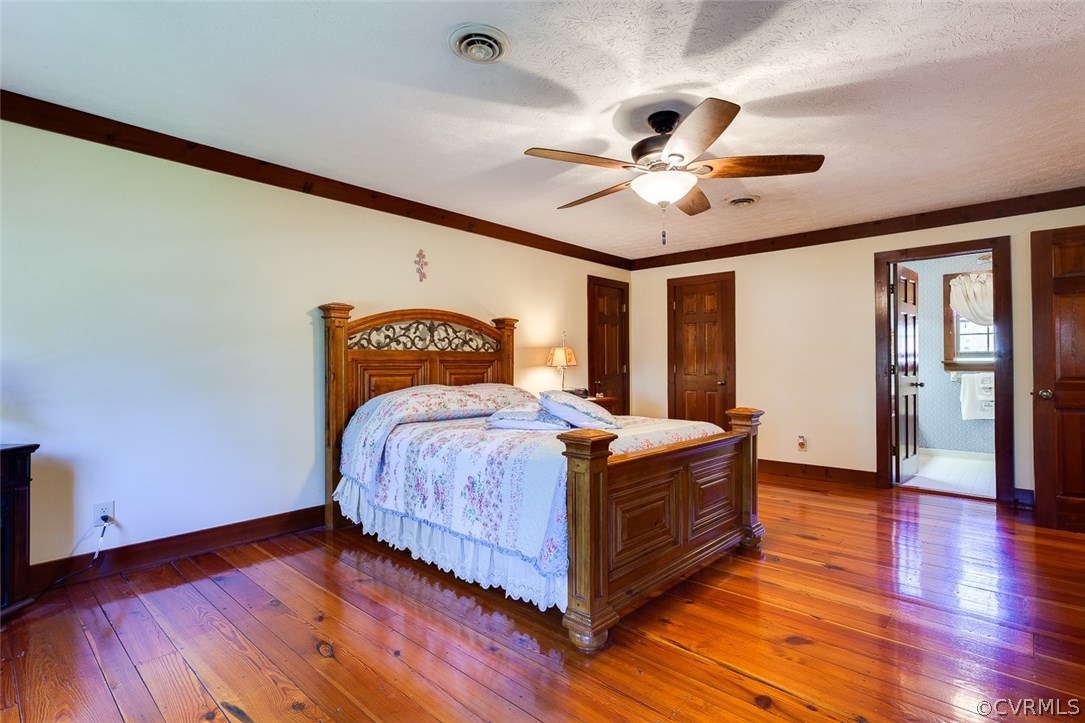 15210 Harrowgate Road Chester, VA 23831 - Photo 16 of 26 a bedroom with a bed and wooden floor