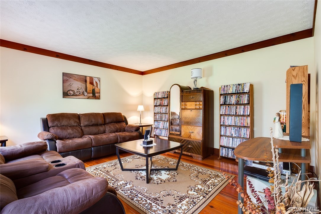 15210 Harrowgate Road Chester, VA 23831 - Photo 5 of 26 a living room with furniture a bookshelf and a large window