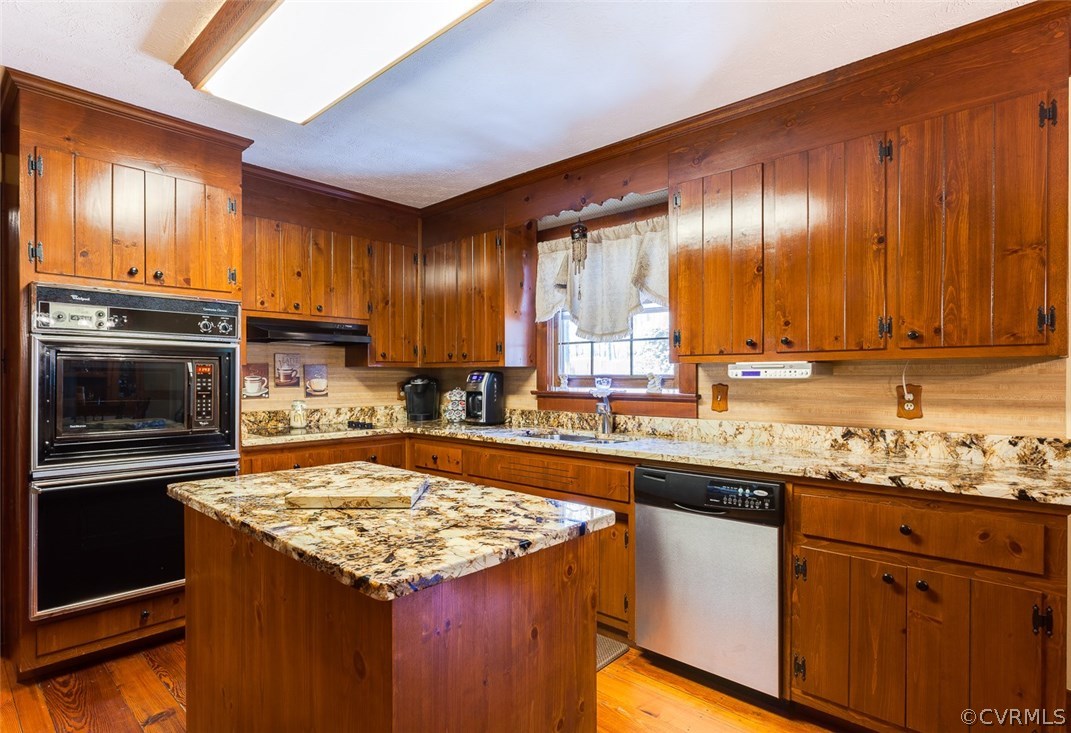 15210 Harrowgate Road Chester, VA 23831 - Photo 7 of 26 a kitchen with granite countertop stainless steel appliances and wooden cabinets