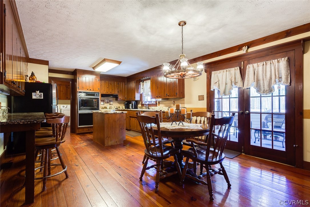15210 Harrowgate Road Chester, VA 23831 - Photo 8 of 26 a large kitchen with a table and chairs