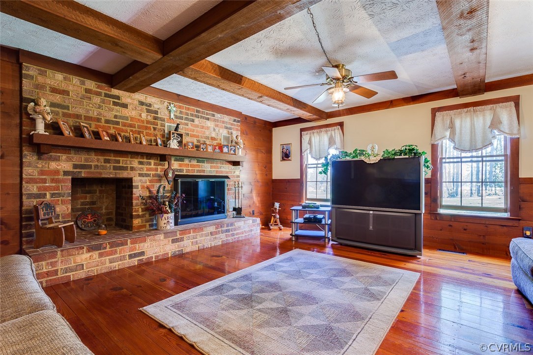 15210 Harrowgate Road Chester, VA 23831 - Photo 10 of 26 a living room with furniture a fireplace and a table