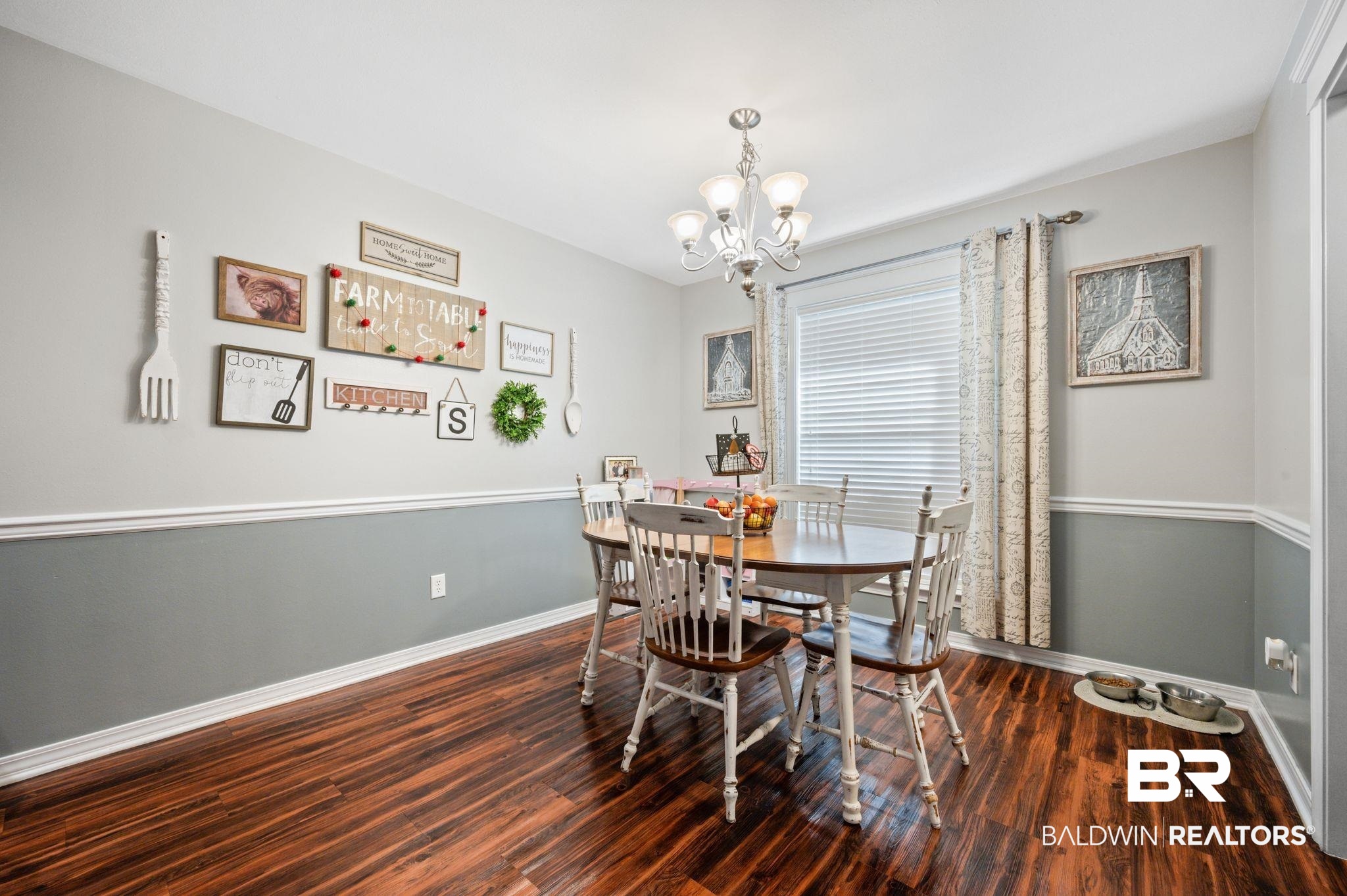 9366 Fox Run Court Semmes, AL 36575 - Photo 11 of 29 Dining area featuring a notable chandelier and dark wood-type flooring