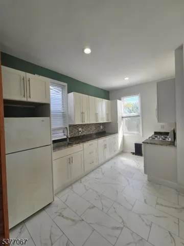 a kitchen with cabinets and white appliances