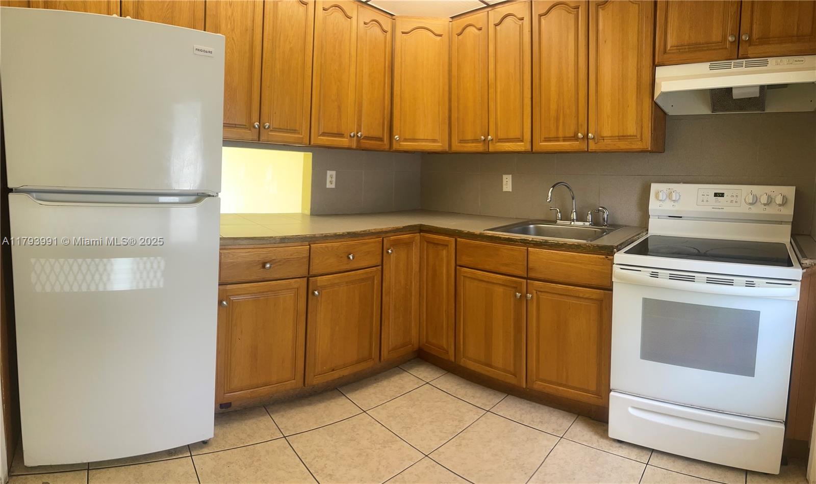 4200 Northwest 3rd Court, Unit 134 Plantation, FL 33317 - Photo 6 of 15 a kitchen with a cabinets and a stove top oven