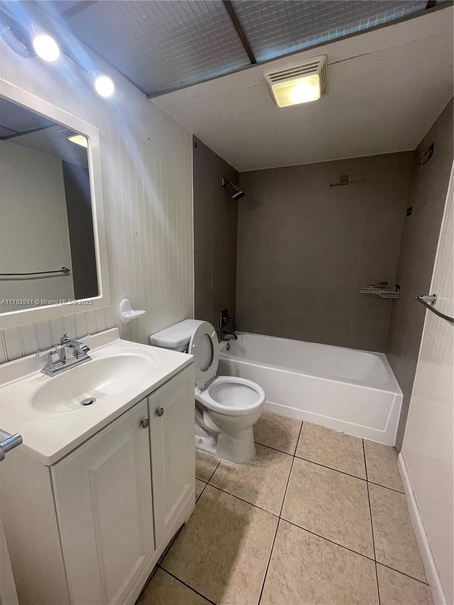 4200 Northwest 3rd Court, Unit 134 Plantation, FL 33317 - Photo 8 of 15 a bathroom with a sink a toilet and shower
