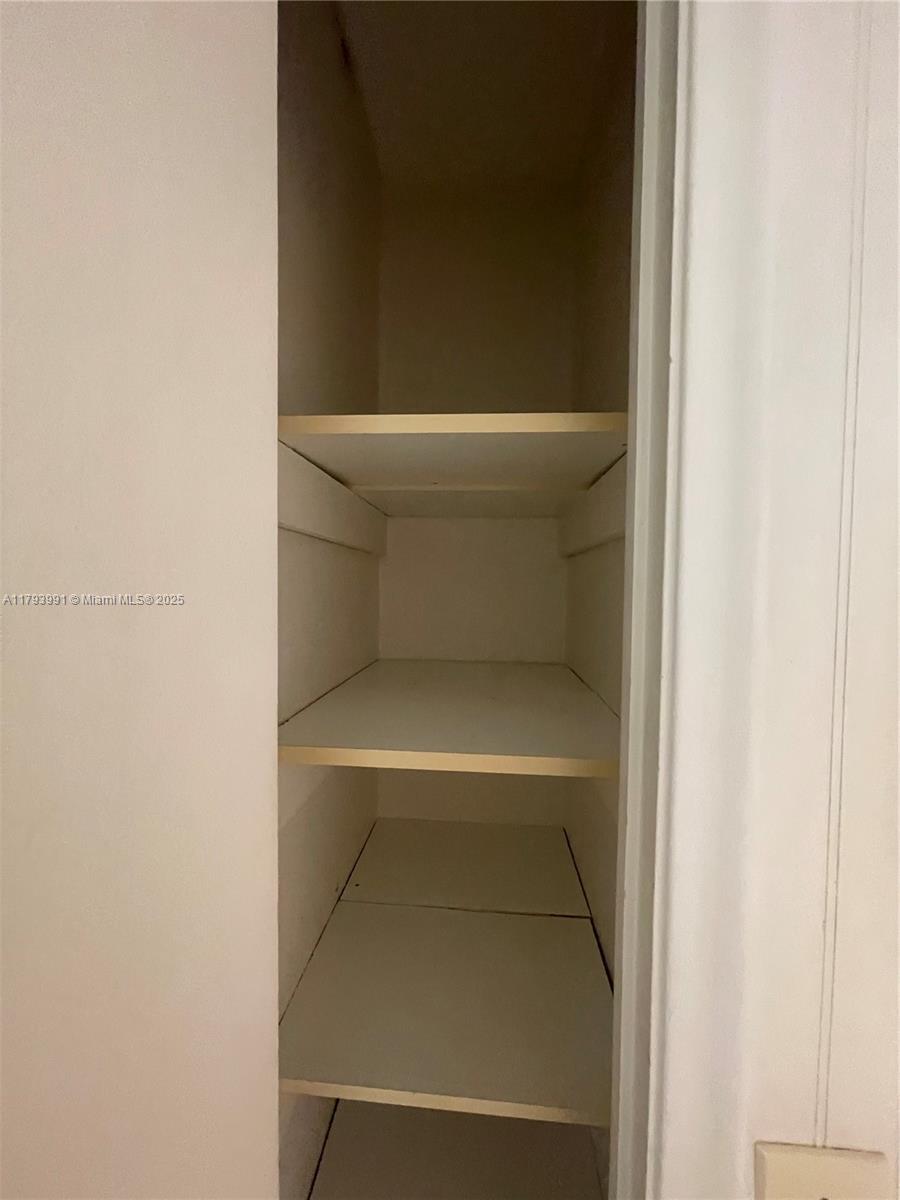 4200 Northwest 3rd Court, Unit 134 Plantation, FL 33317 - Photo 10 of 15 a view of walk in closet with empty racks