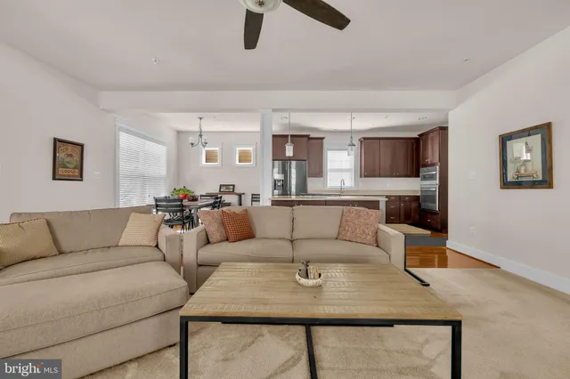 a living room with furniture and kitchen view