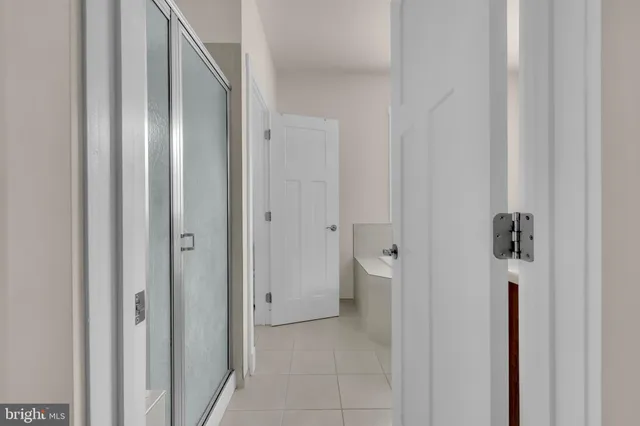 a bathroom with a bathtub sink and mirror