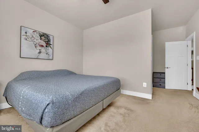 a bedroom with a bed couch and window