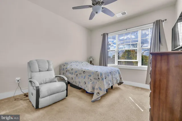 a bedroom with a bed and a television