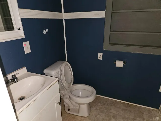 a white toilet sitting next to a bathroom sink
