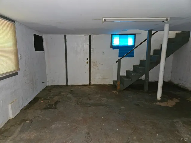 a view of a livingroom with stairs and a window
