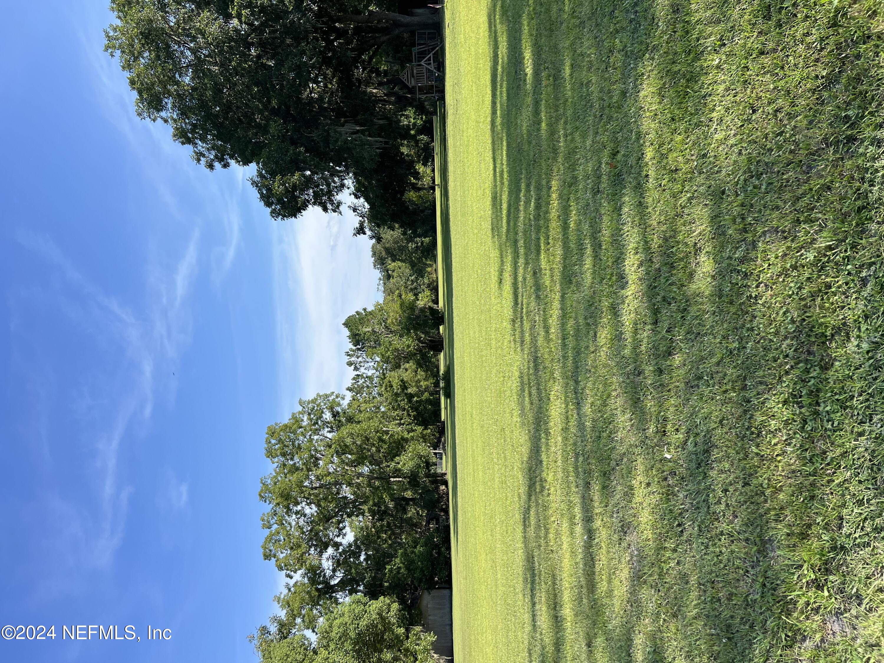 1310 West Madison Street Starke, FL 32091 - Photo 1 of 4 a view of a big yard with a house in the background