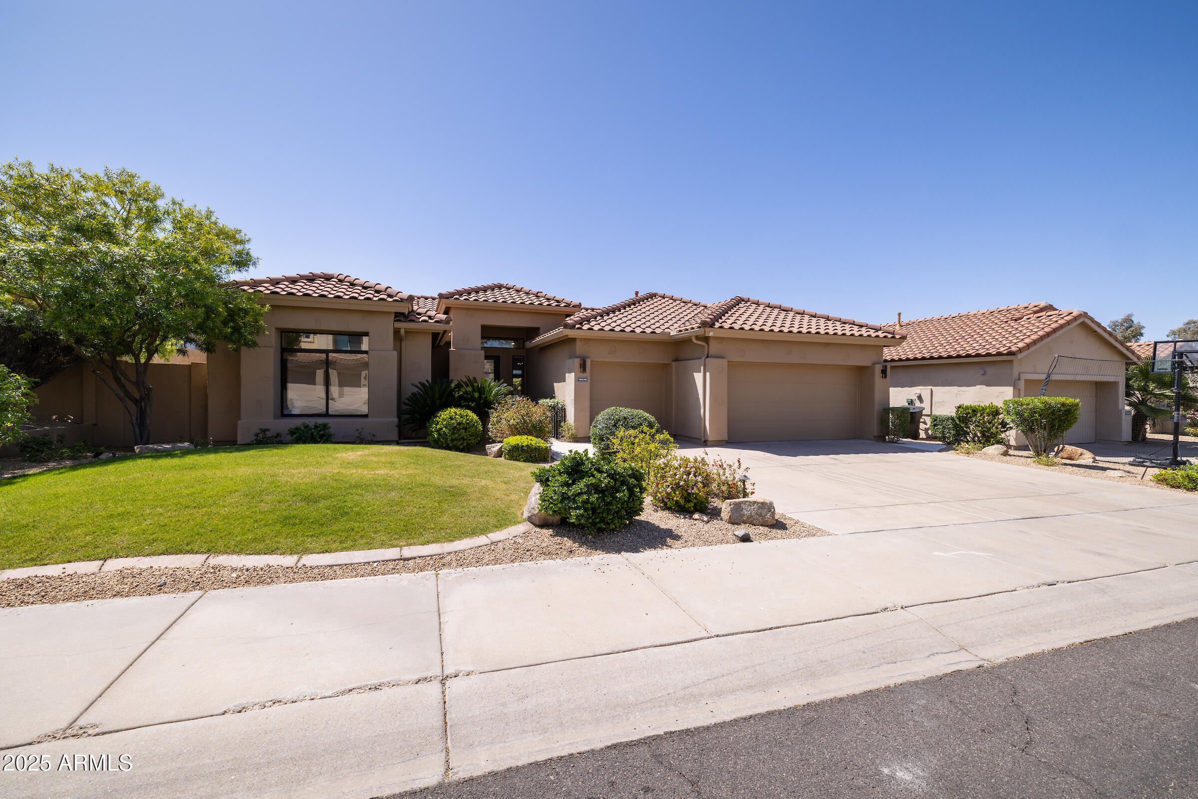14518 North 99th Street Scottsdale, AZ 85260 - Photo 1 of 1 a front view of a house with a garden and yard
