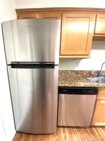 a kitchen with granite countertop a sink and a stove top oven
