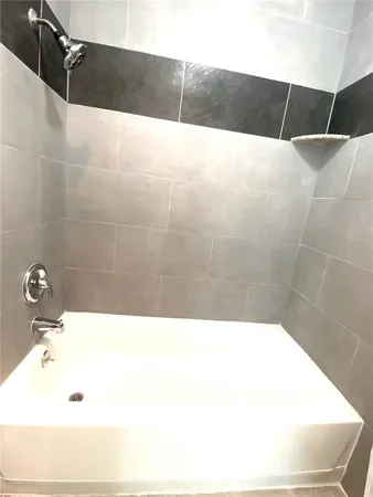 a bathroom with a sink a mirror and a bathtub