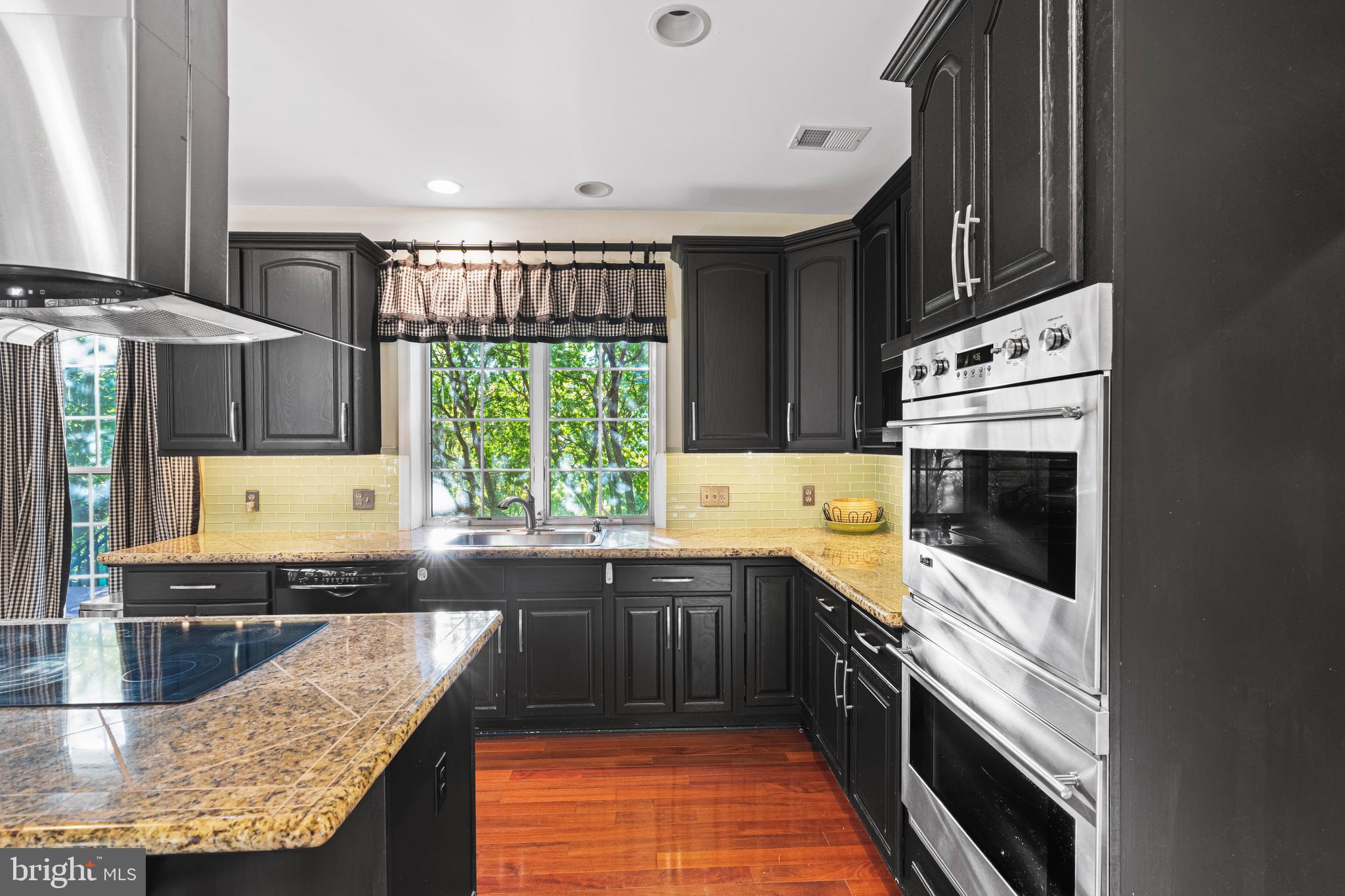 6 Howell Court Princeton Junction, NJ 08550 - Photo 27 of 81 a kitchen with stainless steel appliances granite countertop a stove a sink and a microwave
