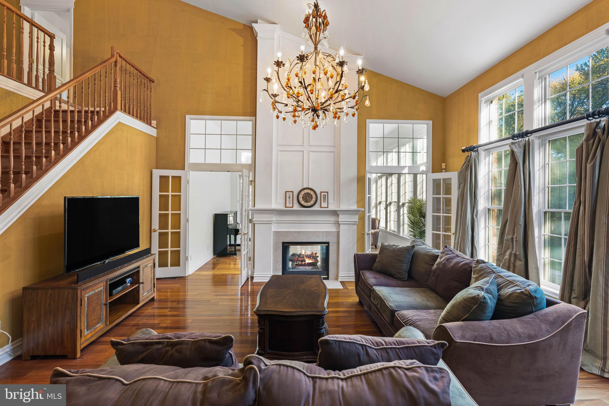 6 Howell Court Princeton Junction, NJ 08550 - Photo 3 of 81 a living room with furniture a fireplace and a flat screen tv