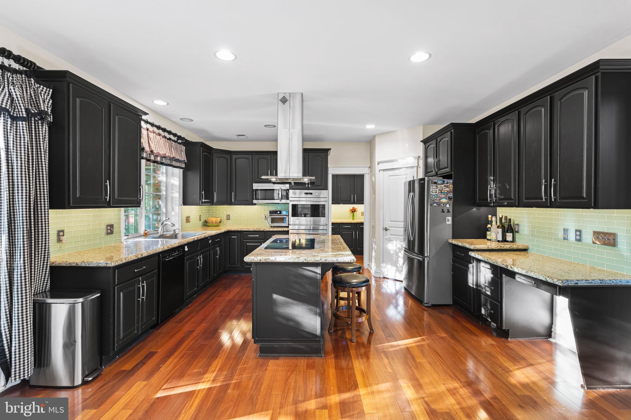 6 Howell Court Princeton Junction, NJ 08550 - Photo 32 of 81 a kitchen with stainless steel appliances a sink a stove a refrigerator cabinets and a kitchen island